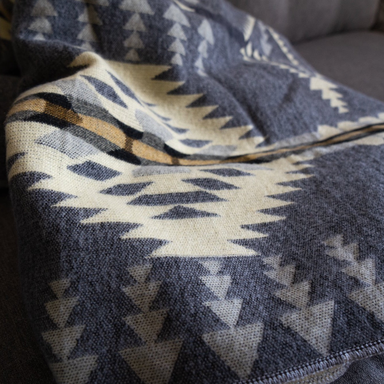 Soft alpaca wool blanket styled on a couch